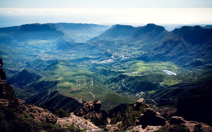 Panoramic view of mountains and valleys with winding roads