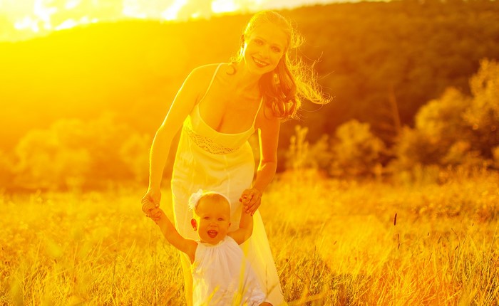 Mother and baby in a sunlit field