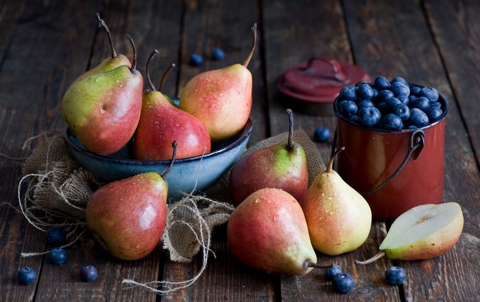 Pears and blueberries on a wooden table