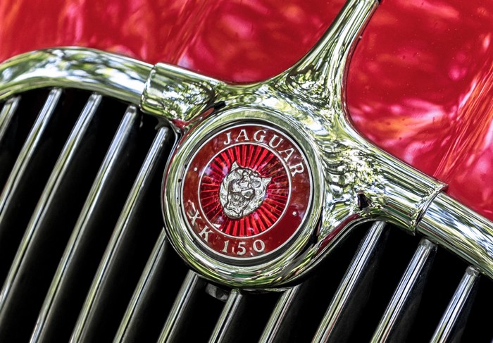Jaguar XK 150 Emblem on Red Car Grill