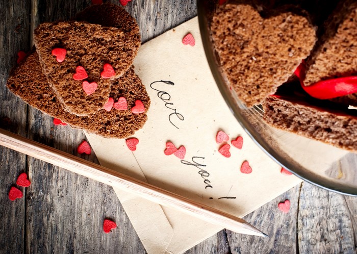 Heart-shaped cookies on a letter with a pencil