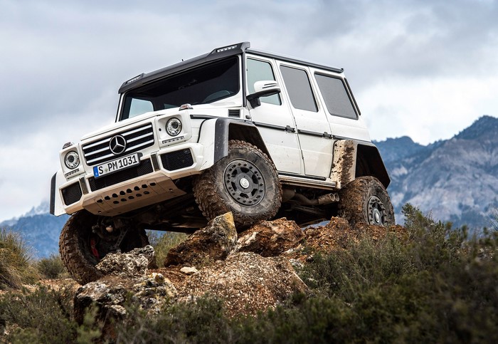 White Mercedes-Benz G500 4x4 off-roading on rocky terrain