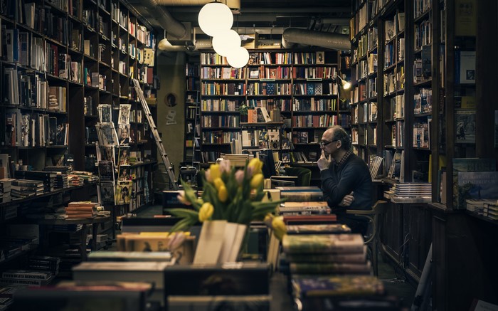 Man in a bookstore with books