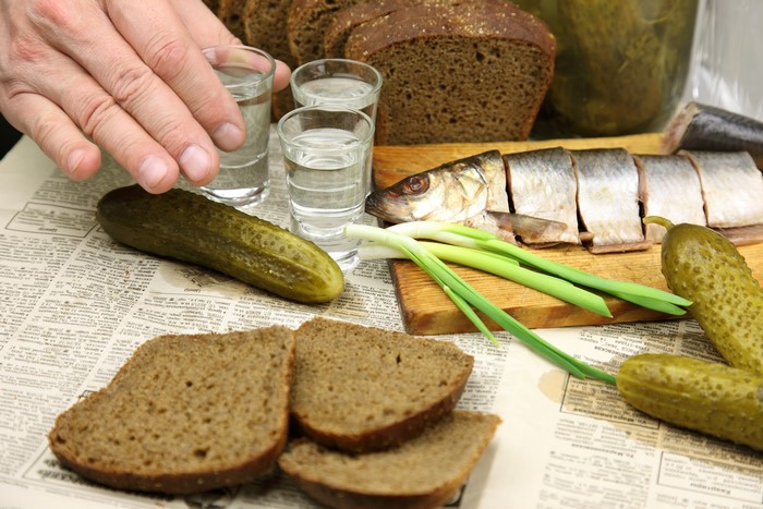 Vodka, Bread, Cucumbers, and Fish with Shot Glasses
