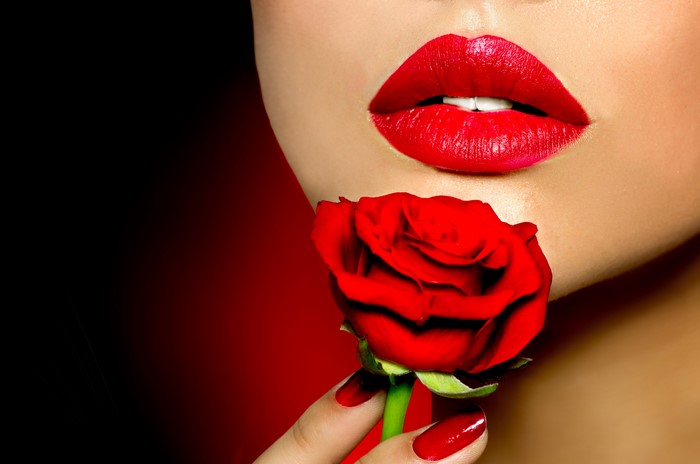 Woman with Red Lips Holding a Red Rose