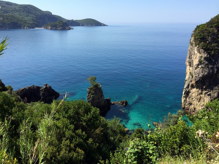 Coastal view of Corfu, Greece with clear blue sea and rocky cliffs