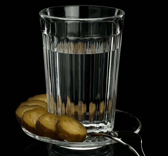 Vodka with sliced cucumbers in a highball glass