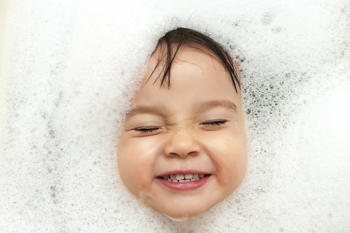 Infant's face covered in foam