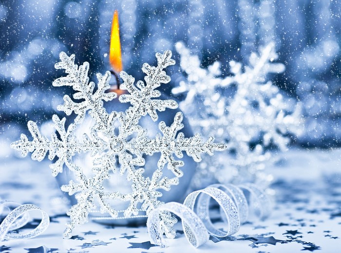 Christmas candle with snowflakes and ribbon