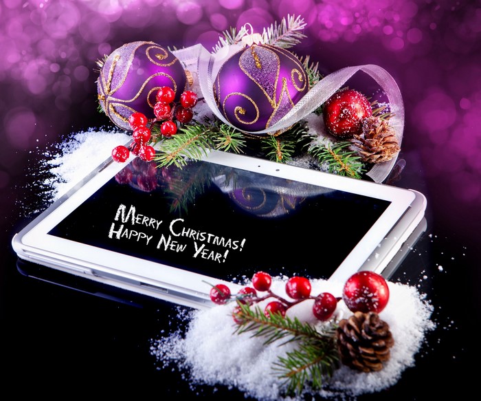 Christmas decorations on a tablet displaying Merry Christmas