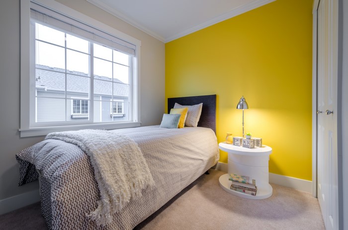 Bedroom with yellow wall and window