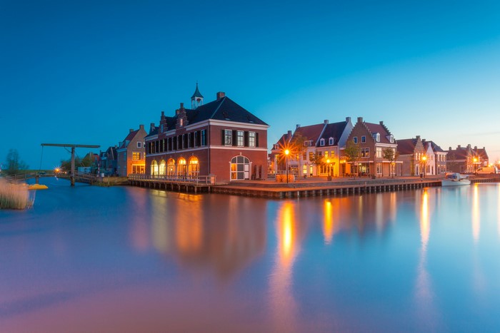 Houses and canal in Anjum, Netherlands at dusk