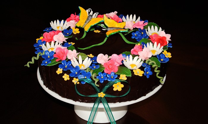 Chocolate cake with floral decorations and butterflies