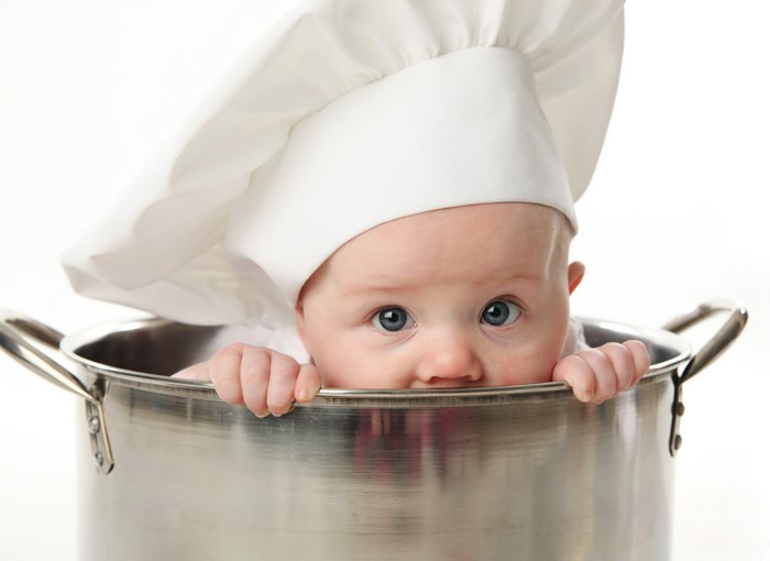 Baby in chef hat in a pot