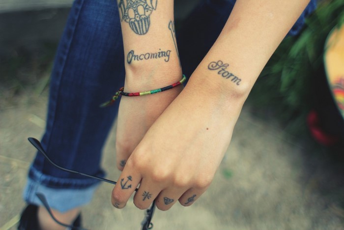 Hands with tattoos and bracelet