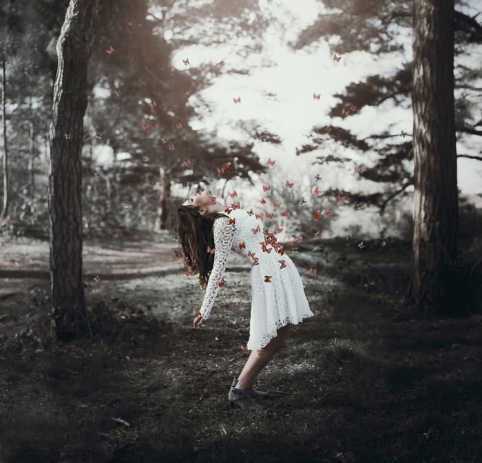 Georgina Walker with butterflies in a forest