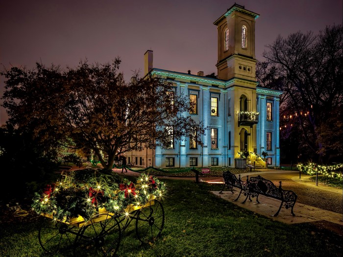 Historic house decorated with Christmas lights and garlands