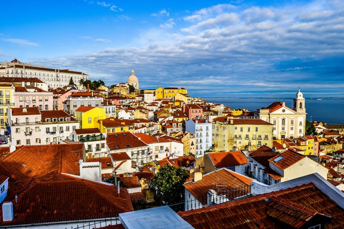 Lisbon, Portugal cityscape with tiled roofs and river