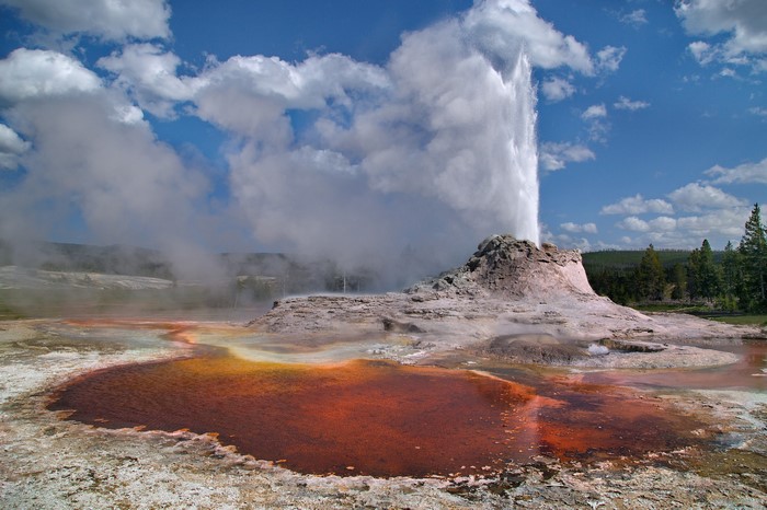 Castle Geyser erupting with steam and water in Yellowstone