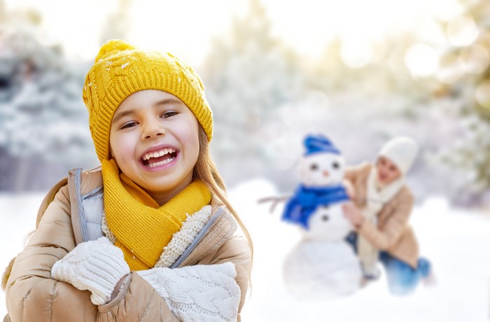 Girl in Winter Hat and Scarf with Snowman