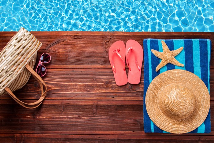 Summer accessories by the pool with starfish and hat