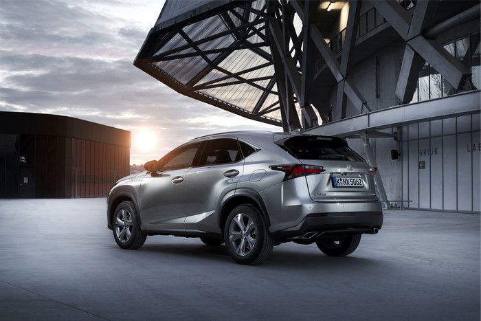 Silver Lexus NX 300h parked near modern architecture