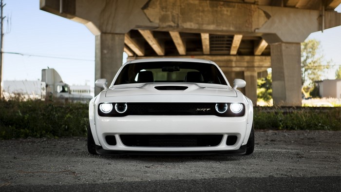 White Dodge Challenger SRT Hellcat parked under a bridge