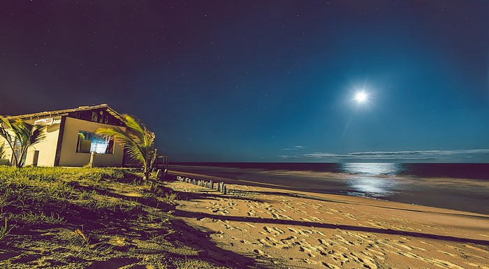 Beach house at night under the moon and stars in Brazil