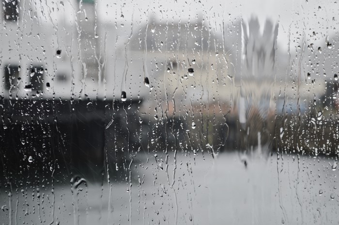 Raindrops on Glass with Blurred City Buildings