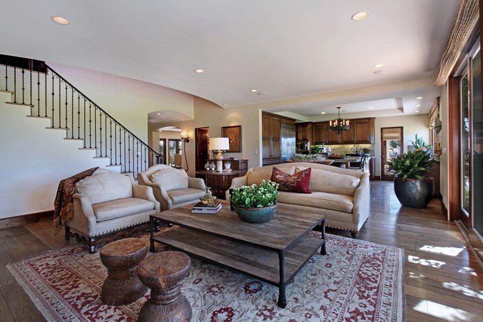 Living room with sofa, armchairs, coffee table, and carpet