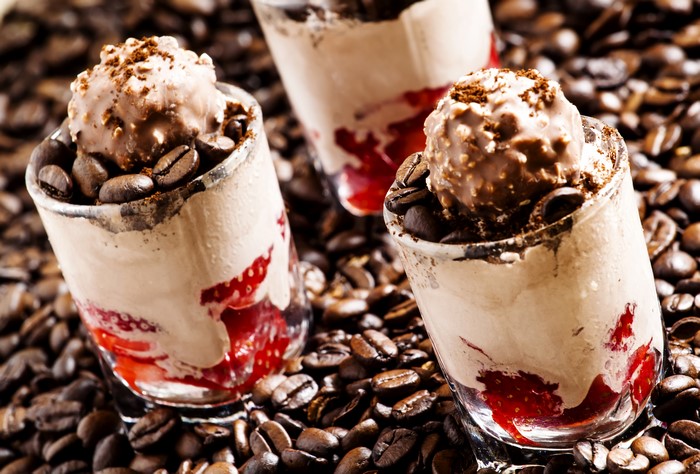 Dessert with ice cream and strawberries in coffee beans