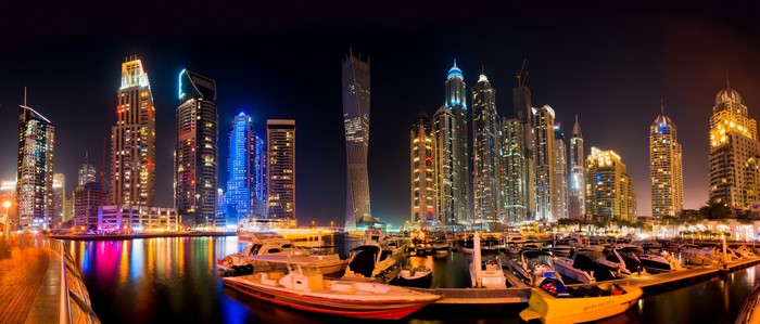 Dubai Marina skyscrapers and boats at night
