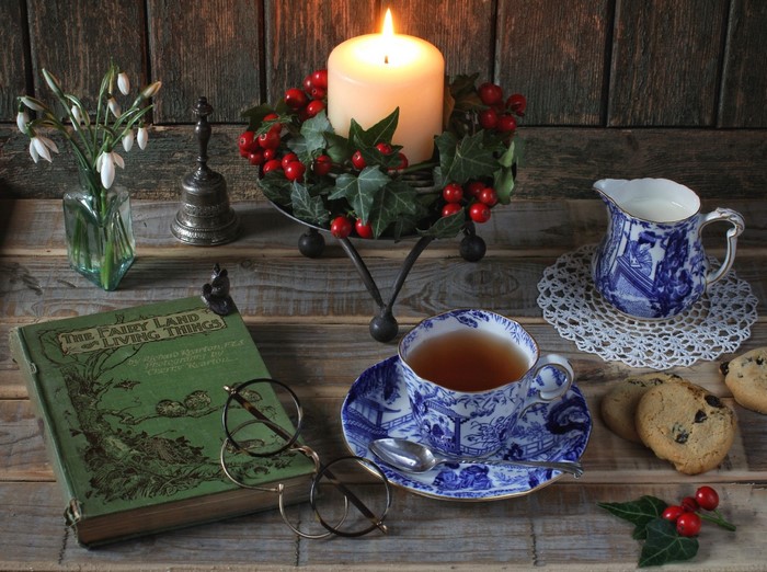 Still life with tea, book, and candle