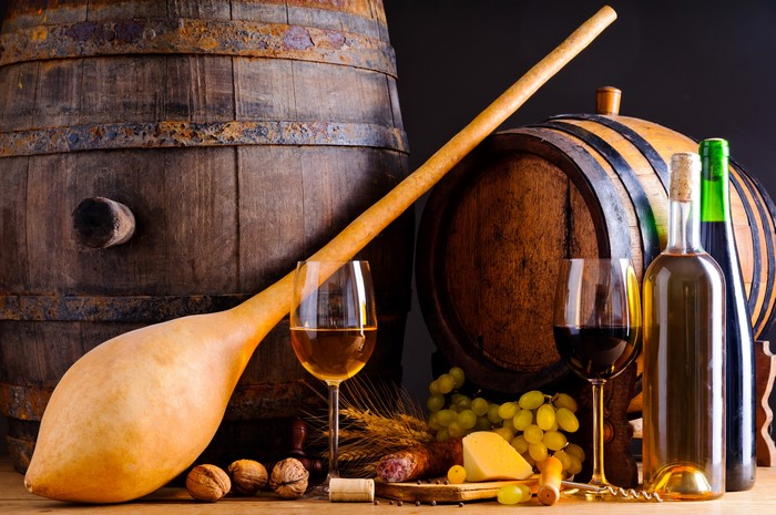 Wine barrels with wine, cheese, sausage, and nuts