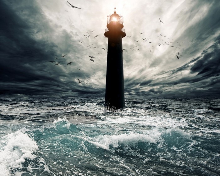 Lighthouse in stormy sea with seagulls