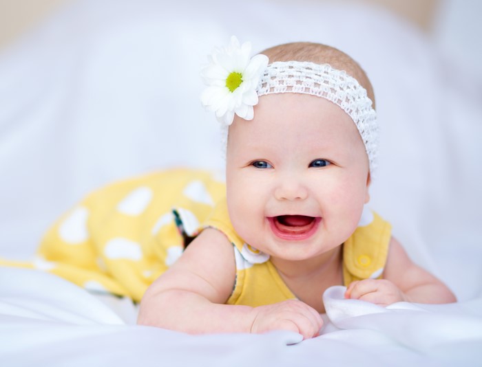 Baby girl with flower headband and yellow dress