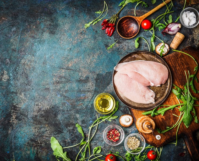 Raw Chicken Breasts with Spices and Vegetables