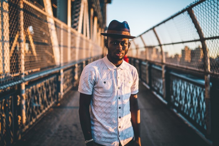 Man wearing a hat on a bridge