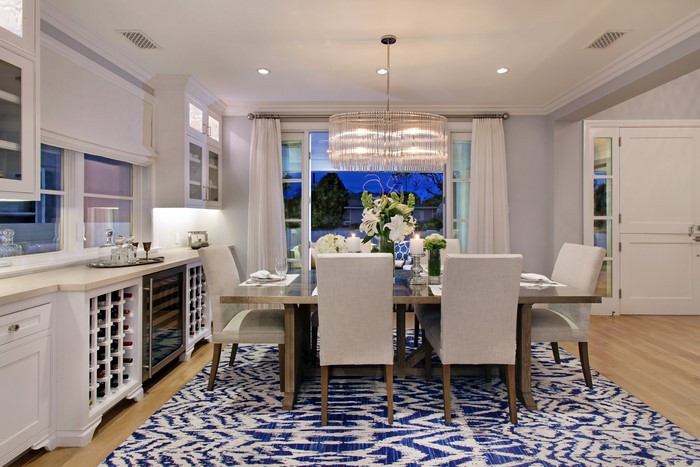 Dining Room with Chandelier and Blue Rug