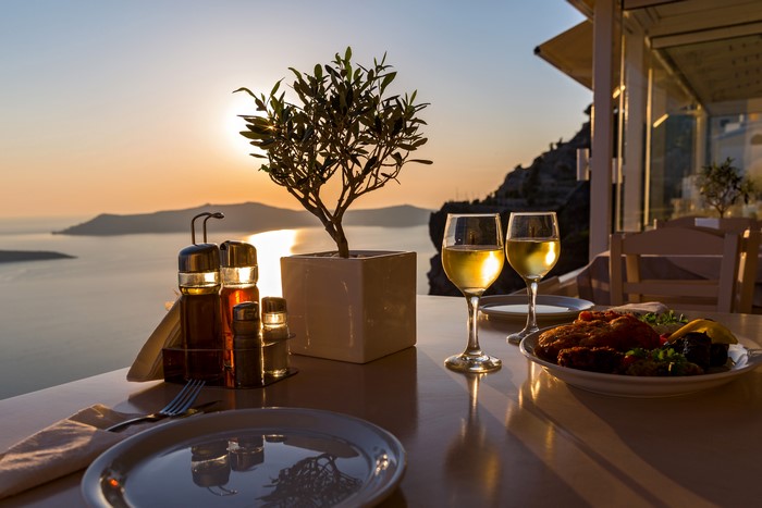 Table setting with wine and food at sunset