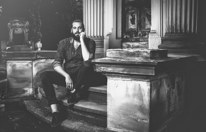 Man sitting on stone steps outdoors
