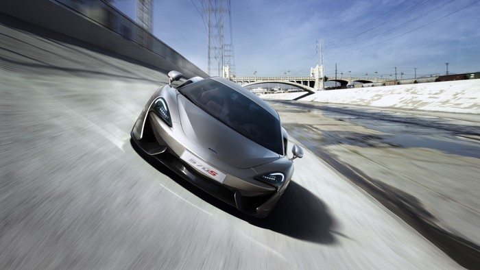 McLaren 570S Coupe driving on a concrete riverbed