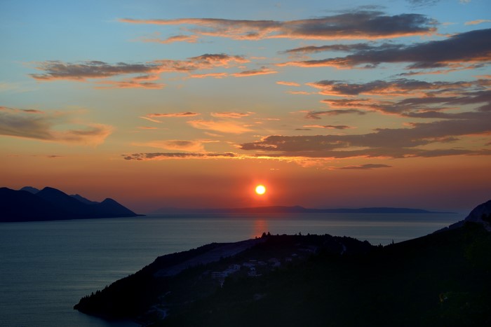 Sunset over the sea in Croatia with mountains
