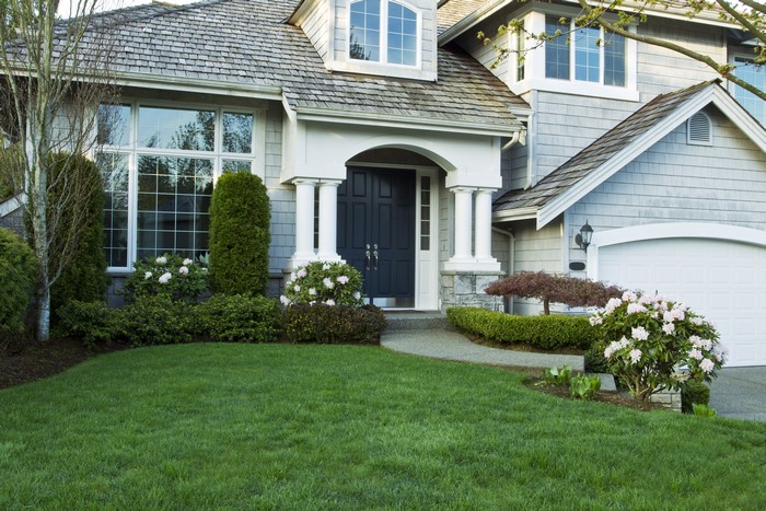 House with lawn and shrubs