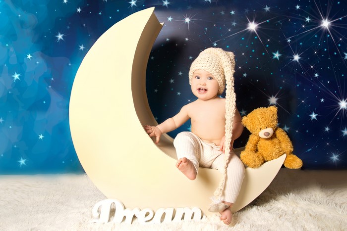 Baby in Winter Hat on Crescent Moon with Teddy Bear