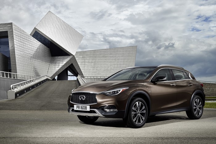 2015 Infiniti QX30 in front of modern architecture