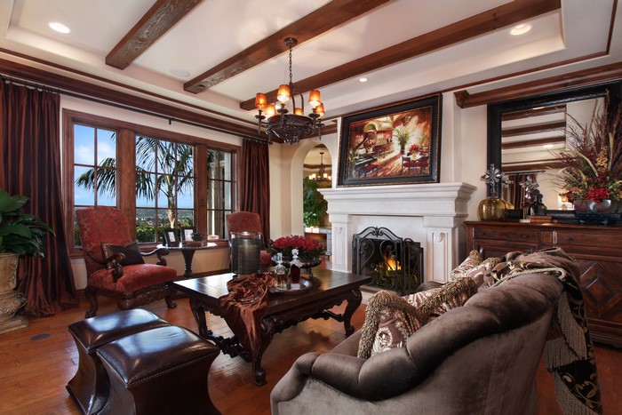 Living room with fireplace, sofa, and armchair