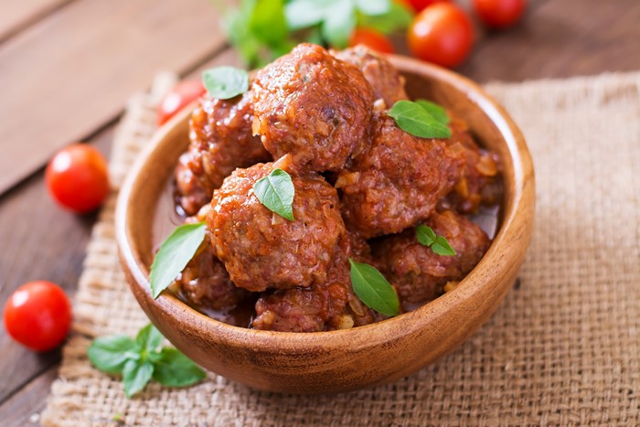 Meatballs in tomato sauce with basil and tomatoes