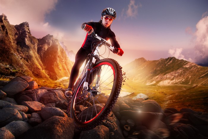 Mountain biker on rocky terrain at sunset