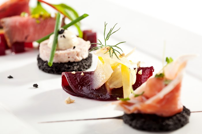 Gourmet appetizers with meat, beets, and prosciutto